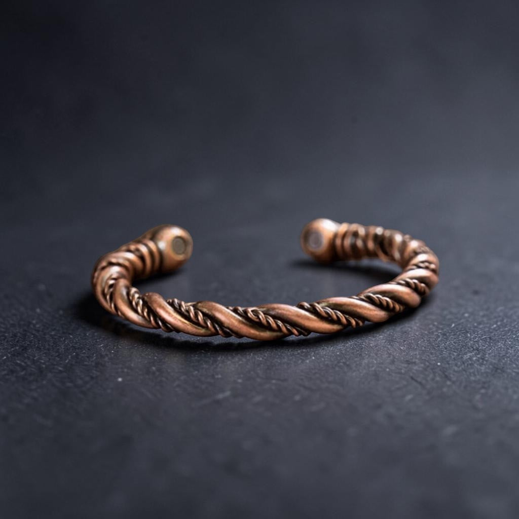 Bronze braided bracelet on a dark surface
