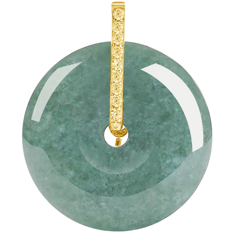 Close-up view of BoxUnboxed natural green jadeite jade doughnut pendant with a sparkling gold vermeil bail.