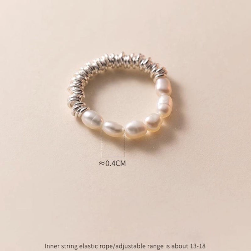 BoxUnboxed ring with baroque pearls and coiled sterling silver band. Features a fluid design and universal fit.