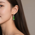 BoxUnboxed green jadeite beaded tassel drop earrings with pavé-set sterling silver huggie hoops worn by a model.