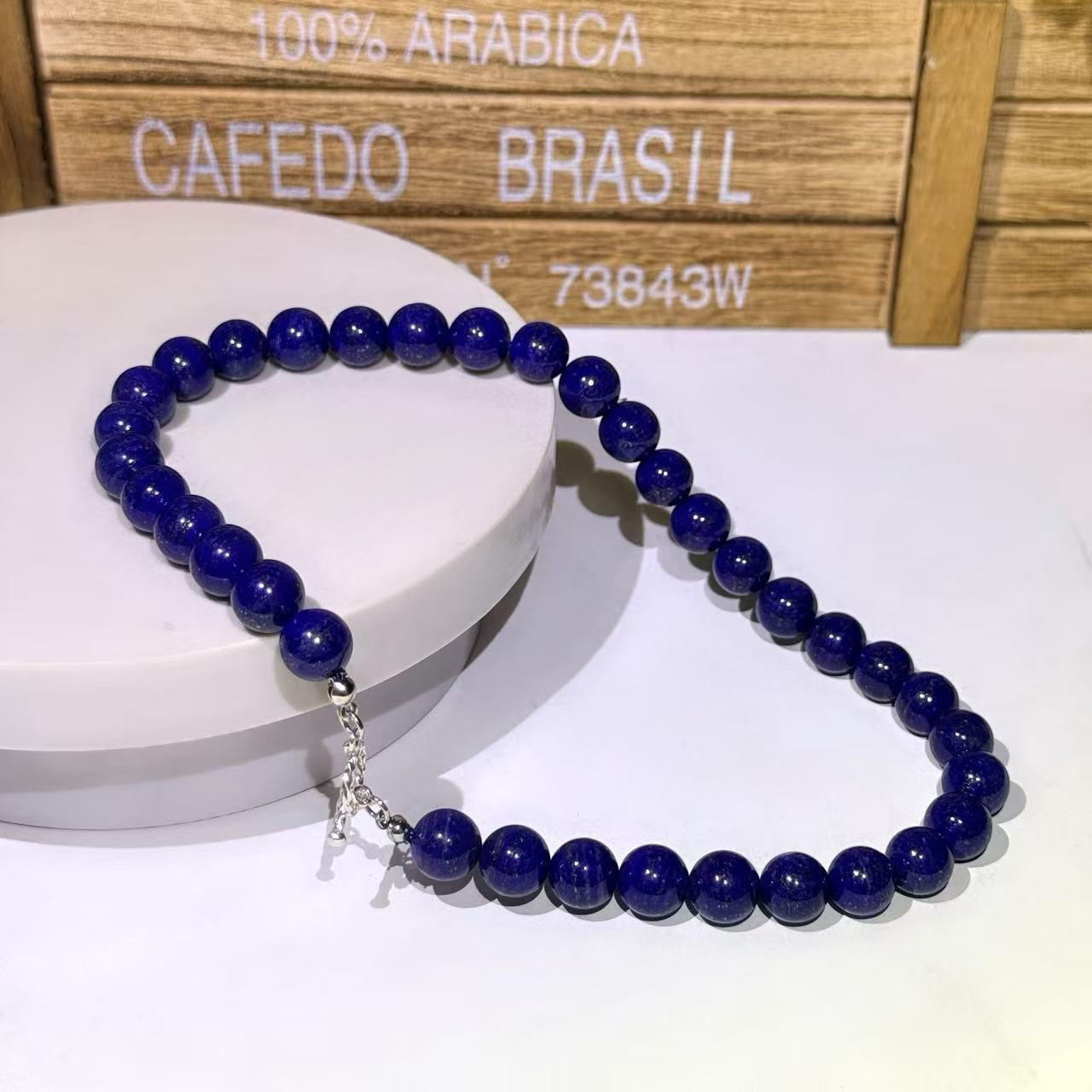 BoxUnboxed natural Afghan Lapis Lazuli beaded necklace with deep royal blue stones and a silver toggle clasp.