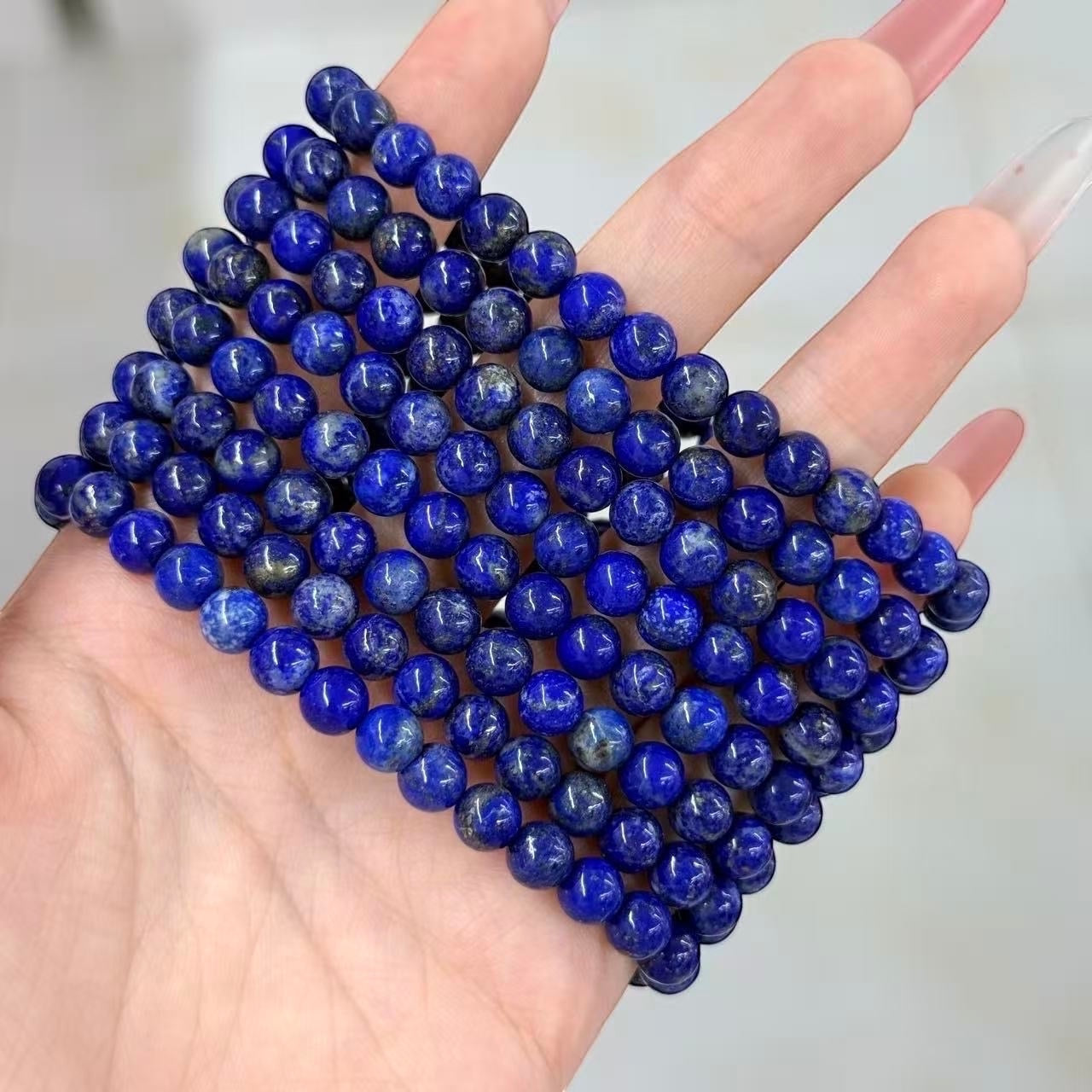 BoxUnboxed natural Afghan Lapis Lazuli beaded bracelet featuring deep indigo stones with subtle golden pyrite inclusions.