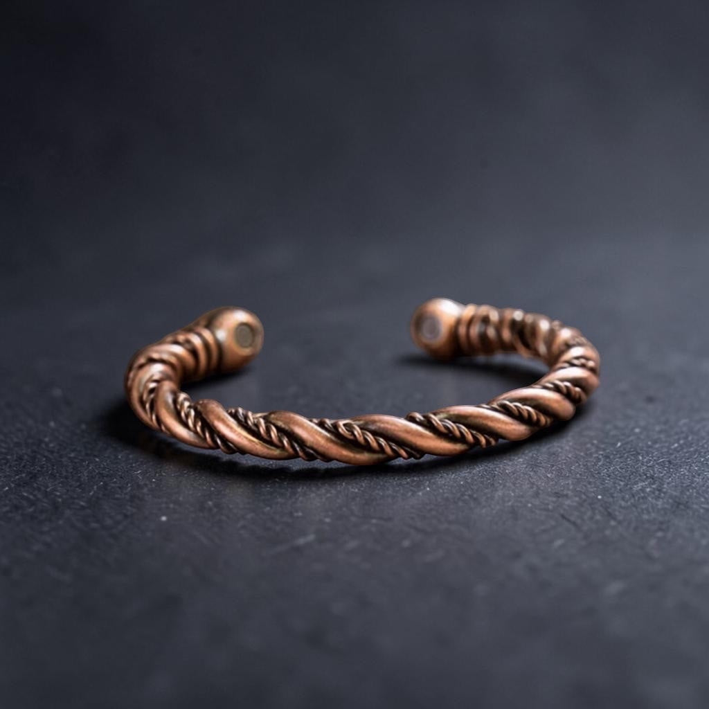 BoxUnboxed Element Cuff, a twisted twin-wire pure copper bracelet with magnetic end caps on a dark textured surface.