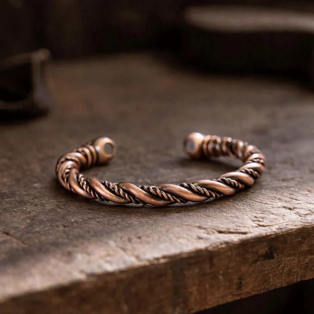 BoxUnboxed pure copper open-cuff bracelet with a twisted twin-wire design and embedded biomagnetic therapy end caps.