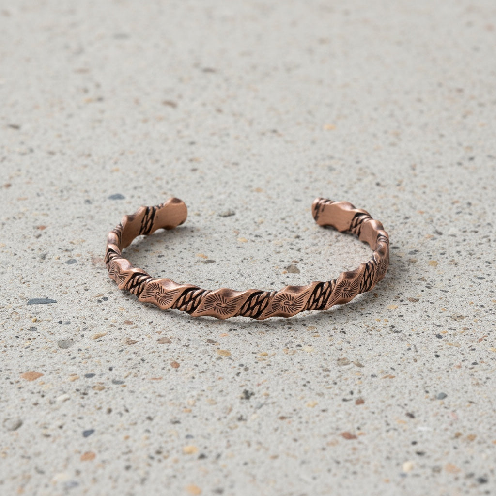 BoxUnboxed Helix Grounding Cuff in 99.99% pure twisted copper with geometric sun patterns and a two-tone finish.